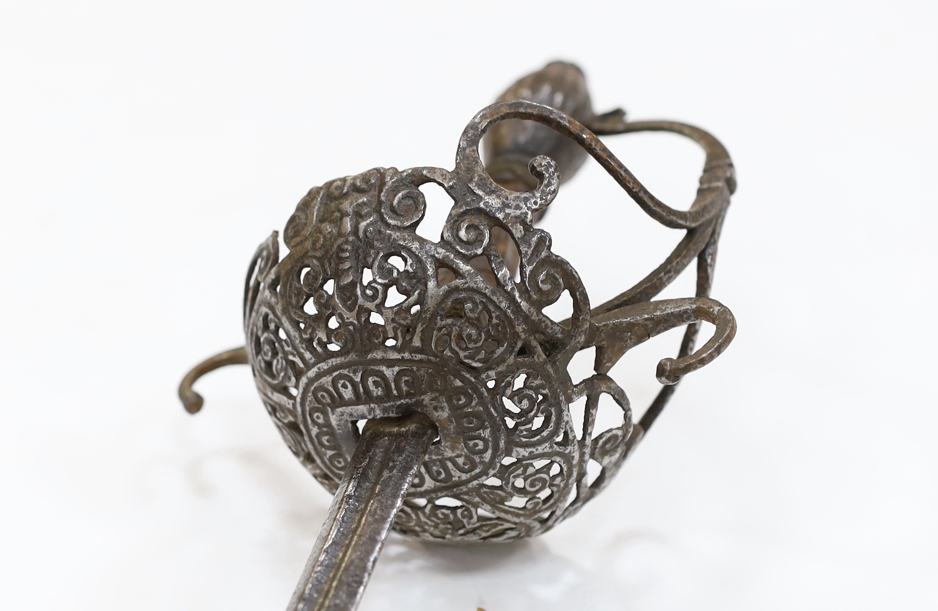 A mid 17th century English rapier, with pierced and chiselled cup guard, steel pommel and leather grip, blade 81cm